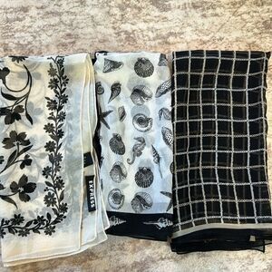 Three black and white silk or polyester square scarves